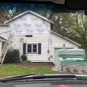 house construction, house has been house wrapped, drywall and supplies outside home