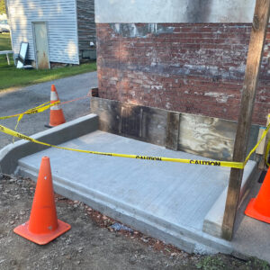 Concrete pad, curb, and parge